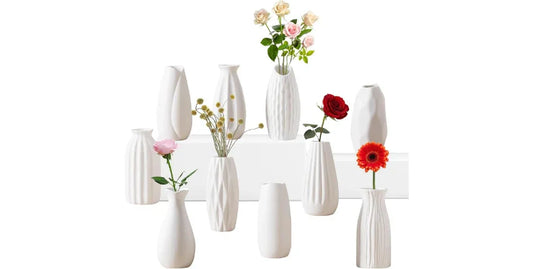 Set of 10 white ceramic bud vases with textured designs, some holding colorful flowers