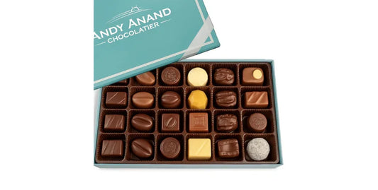 Open box of assorted Andy Anand sugar-free Belgian chocolate truffles in various shapes and colors