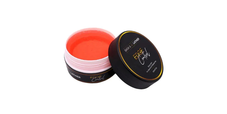 Open container of BASK & LATHER Strong Hold Edge Control Gel with orange gel and black lid