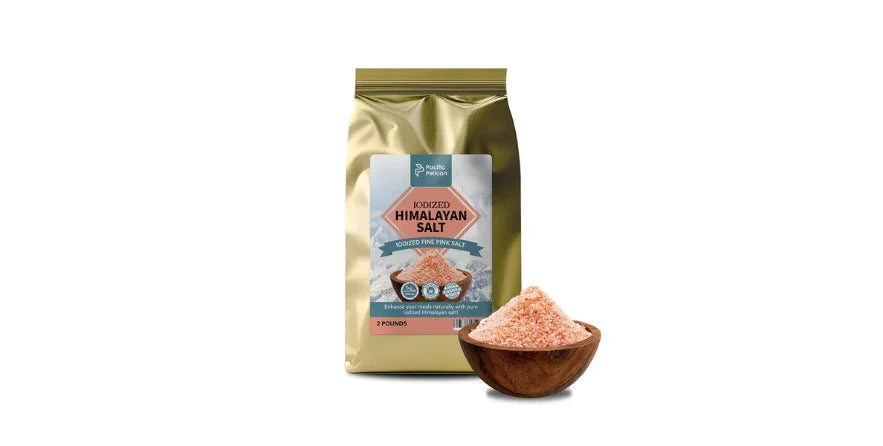 Gold bag of Pacific Pelican iodized Himalayan pink salt with a wooden bowl of pink salt granules