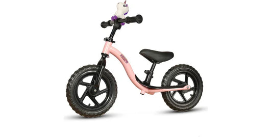 Pink toddler balance bike with black wheels, black seat, and a white unicorn handlebar decoration